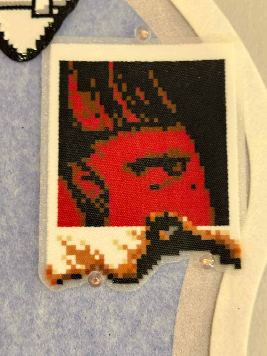 Polaroid-style pixel portrait fused from mini beads in red, black and brown
